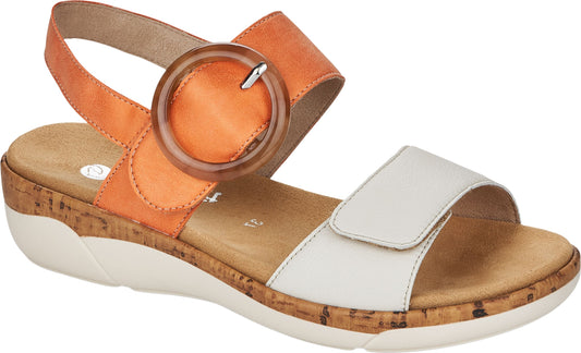 Sandal featuring an orange strap with a circular buckle around the ankle and a white strap over the toes, all atop a cork footbed and a white sole.