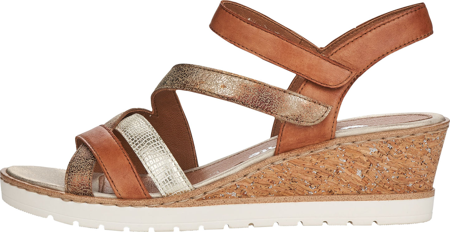 Side view of a heeled sandal with light brown leather straps and a gold snakeskin-textured strap, set on a light-colored cork wedge and white sole.
