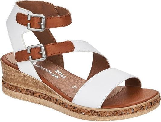 White sandals with brown straps and silver buckles, set on a low, wooden wedge heel.