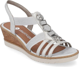Silver sandal with elastic straps, wedge heel, and decorative metal embellishments.