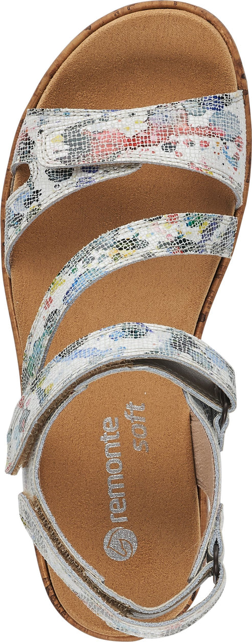 A sandal with white straps and floral patterns.