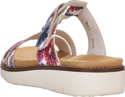 Open-backed, platform sandal featuring floral pattern straps and adjustable Velcro ankle strap.