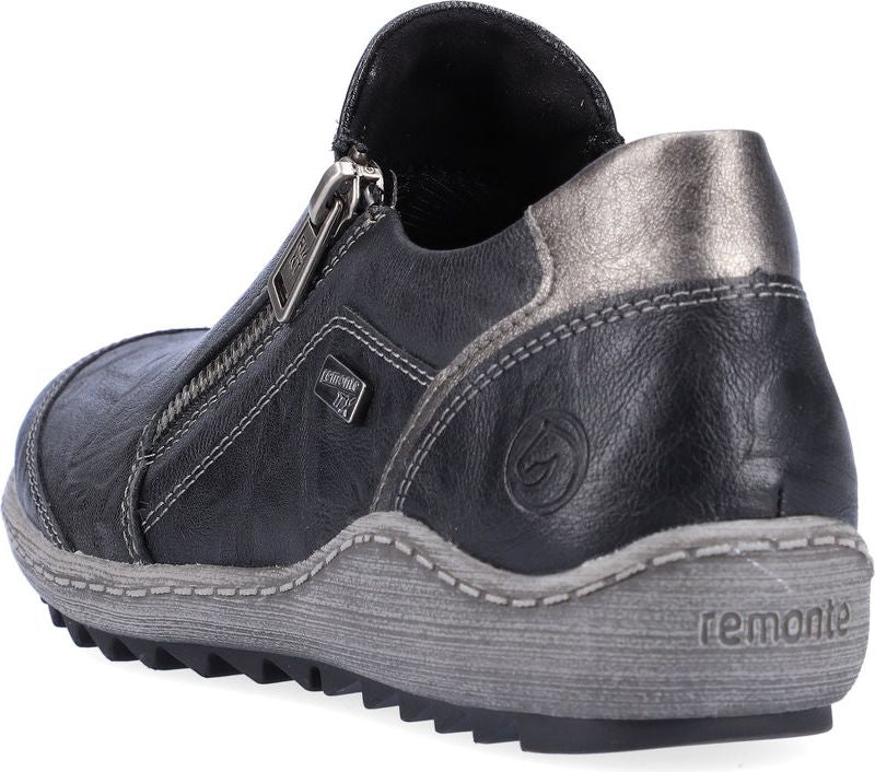 Low black leather slip-on shoe with silver zipper detail and grey sole.