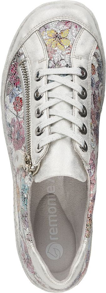 Silver floral sneaker with a zipper.