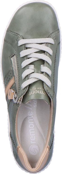 A green sneaker with white laces and a silver zipper on the side.