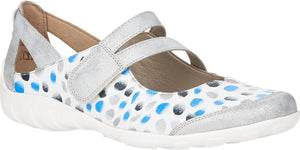 A Mary Jane style shoe with silver straps and a white base with blue and grey polka dots.