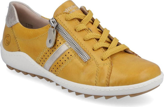 A mustard yellow leather sneaker with zipper, white sole and a gold heel patch.