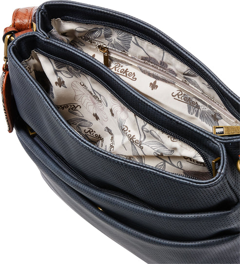 Open, navy blue purse interior with floral lining and zipper pocket.