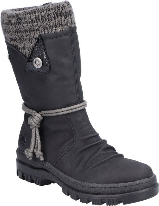 Mid-calf height black boot with knitted wool cuff and cord accent.