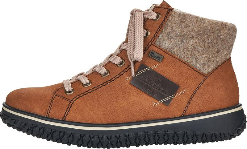 Tan ankle boot with laces, a dark sole and light brown wool at the ankle.