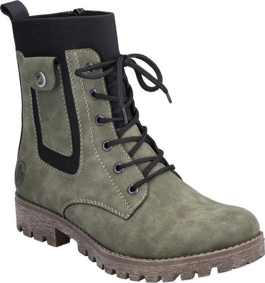 Olive-green boot with laces, short black sock top, and lug sole.