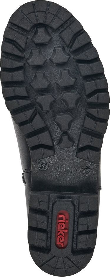 Close-up of a boot sole with a rugged, textured tread pattern and the text 'Rieker' visible.