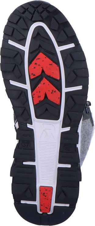 The sole of a boot, featuring black treads with white supports and red accents.