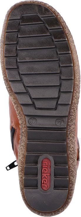The shoe features a dark sole with horizontal treads and a 'Rieker' logo near the heel.