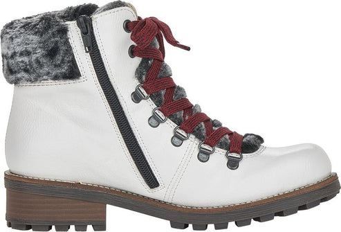 White ankle boot with faux fur trim, lug sole, side zipper, and red laces.