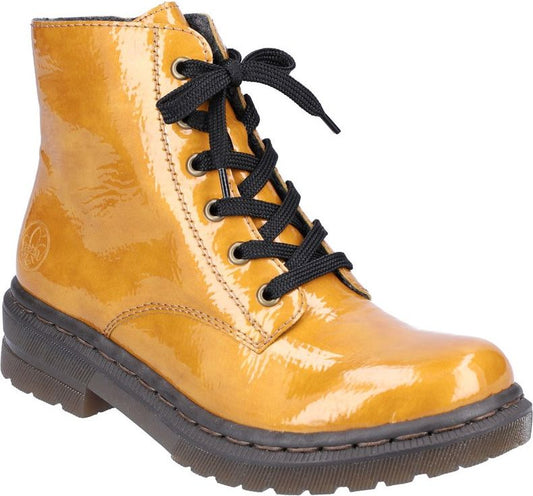 Lace-up ankle boot in mustard yellow patent leather with black laces and lug sole.