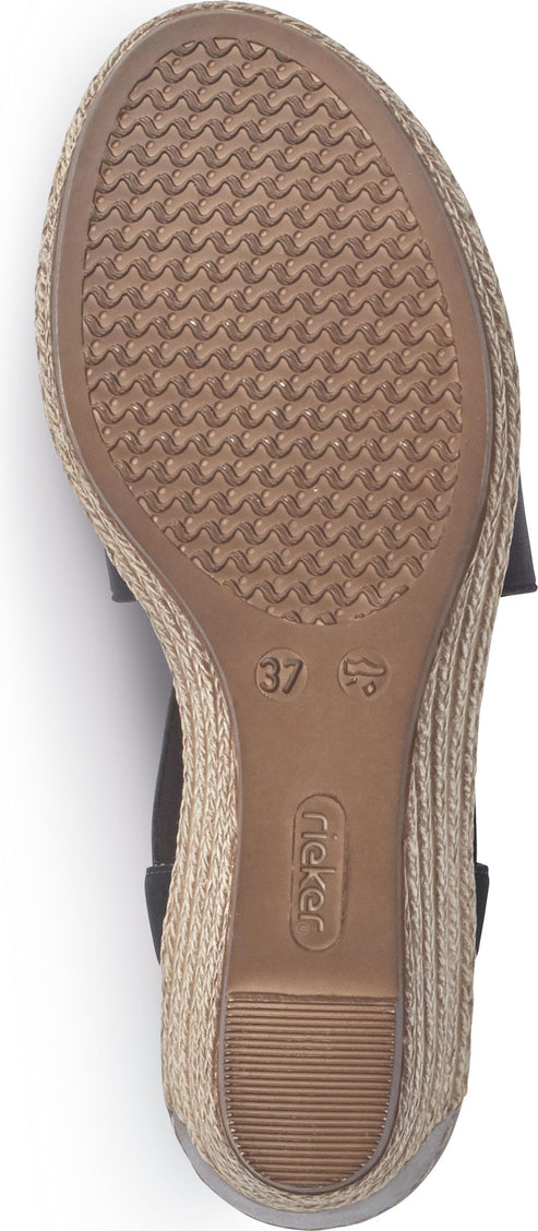 The sole of a wedge sandal with a dark brown bottom. The sole has a rippled texture and a "37" and a logo in the middle.