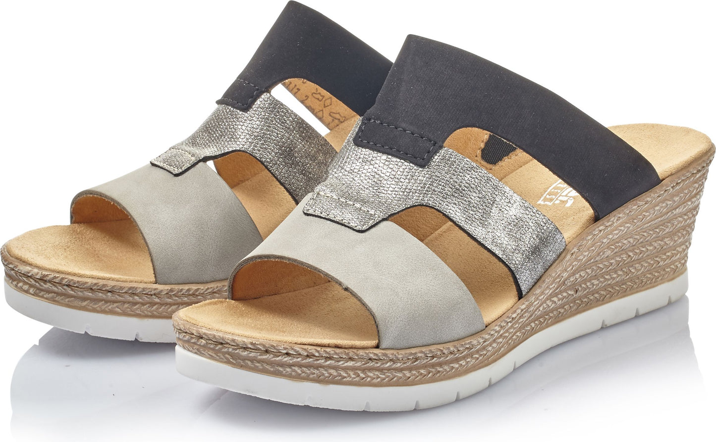 A pair of wedge heeled slides with gray, silver and black straps, jute sides, and a white sole.