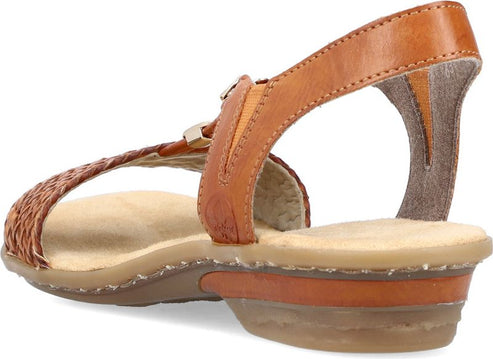 Tan sandal with a woven toe strap, t-strap, and ankle strap.