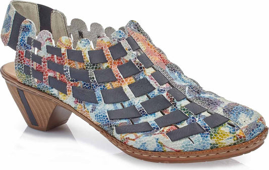 Patterned open heeled shoe with geometric block heel and lattice style overlay.