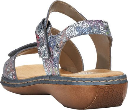 Low heel sandal with velcro strap and abstract floral pattern.