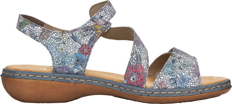 A sandal with crisscrossing straps and flower patterns.