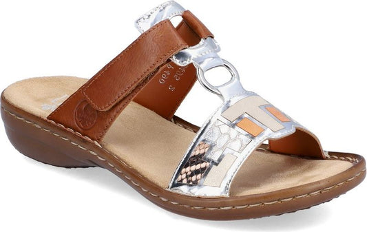 Tan slide sandal with a hook-and-loop strap and silver, geometric accents.