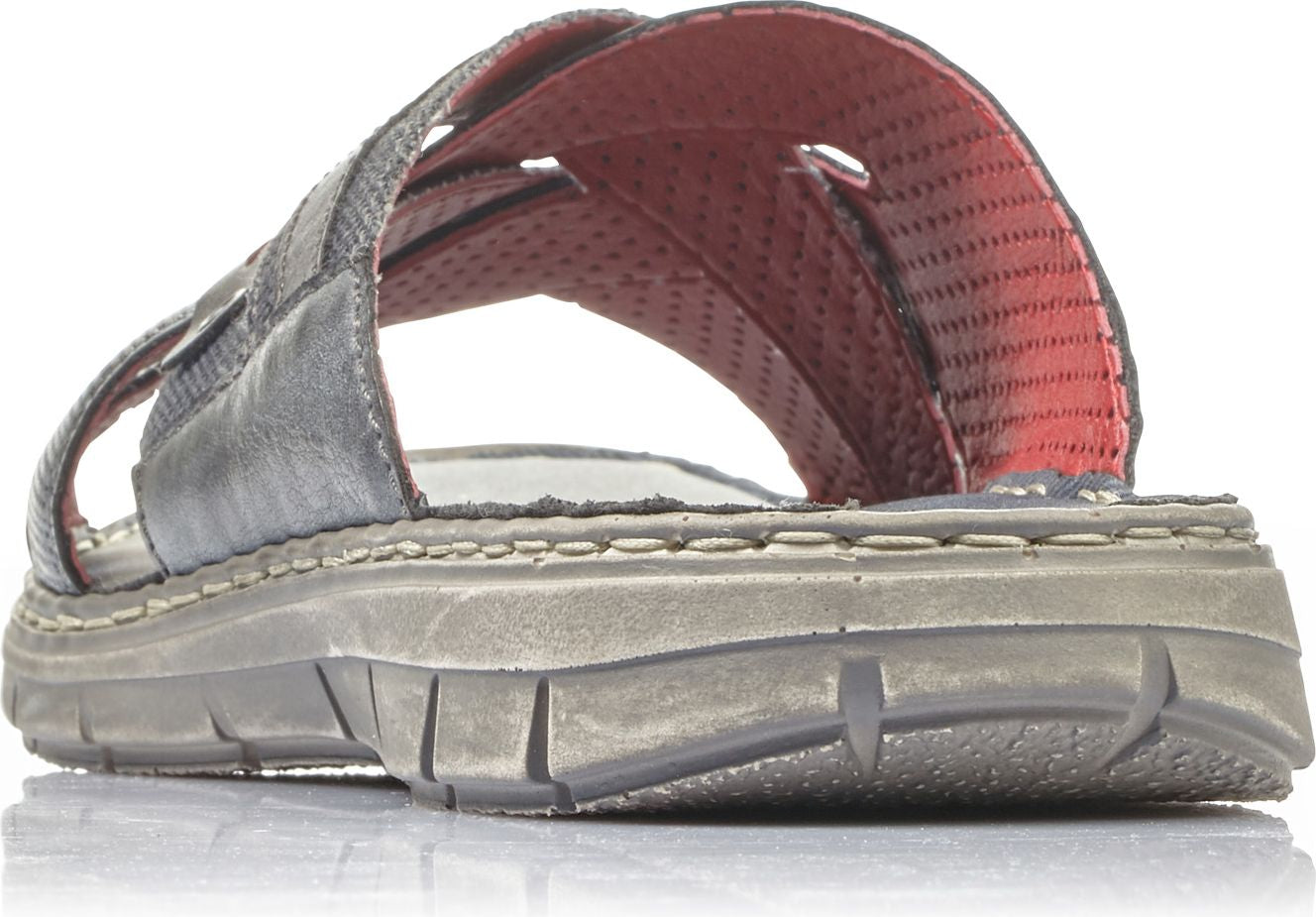 Close-up of a gray sandal featuring multiple crossed straps and a red insole.