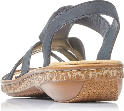 Grey sandal with criss-cross straps and a low cork and rubber heel.