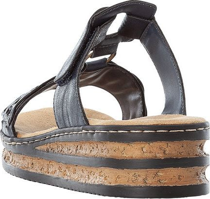Black platform sandals with tan insoles and velcro straps.
