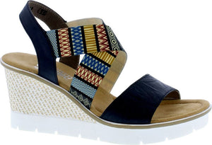 Wedge sandal with navy and colorful patterned straps, tan insole and white sole.