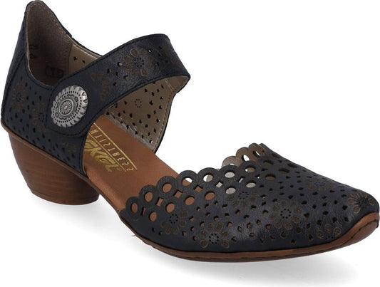 A women's black Mary Jane style shoe with a scalloped and perforated design, side medallion, and low block heel.