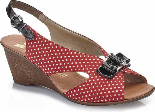 Red wedge heel slingback sandal with white polka dots and a black patent leather bow.