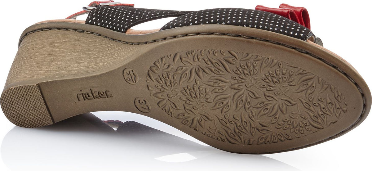 Bottom view of a wedge sandal with polka dots.
