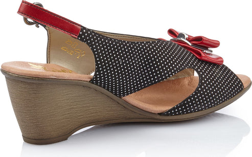 Wedge sandal with black and white polka dots, red bow and ankle strap.