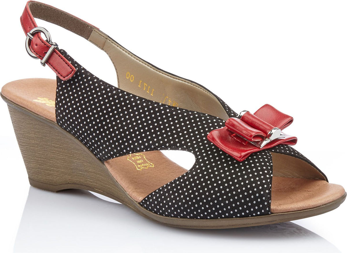 Black and white polka dot wedge sandal with red bow and slingback strap.