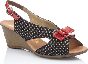 Black and white polka dot wedge sandal with red bow and slingback strap.