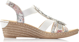Wedge sandal with white straps and floral accents.