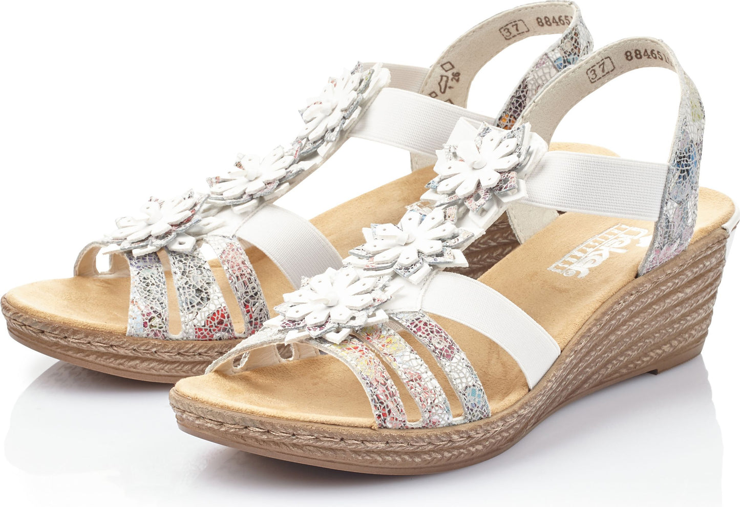 Pair of wedge sandals with white straps, flower accents, and floral patterns.