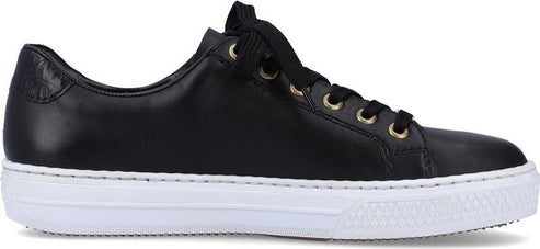 A black low top sneaker with a white sole.