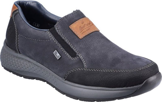 Slip-on shoe in blue with gray soles, black toe, and a brown label.