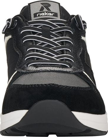 Close-up of a black athletic shoe with white laces and a white stripe design.
