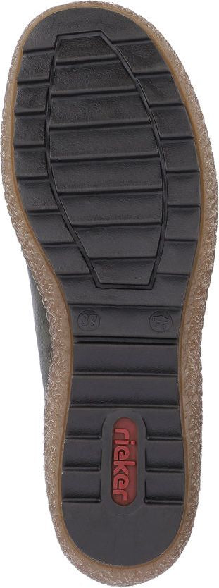 The sole of a shoe with a thick, dark tread and a brand label embedded in the heel.