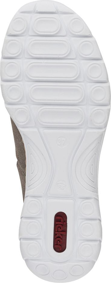 A white shoe sole with oval and circular tread patterns and a red logo in the middle.