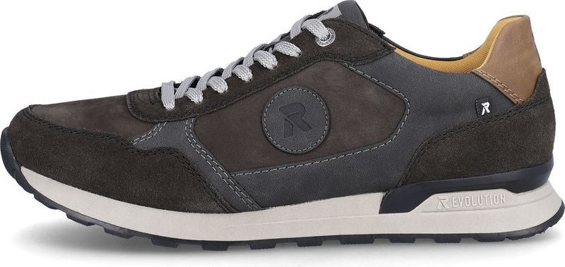 A low-top sneaker featuring a round emblem, combination suede and smooth leather upper, white midsole, and lug outsole.