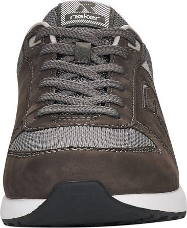 Gray athletic shoe with gray laces and a white and gray padded tongue.
