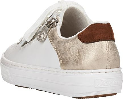 White sneaker with gold accents, a brown heel patch, and a side zipper.