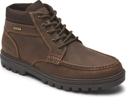 Brown ankle-high boot with dark soles and laces.