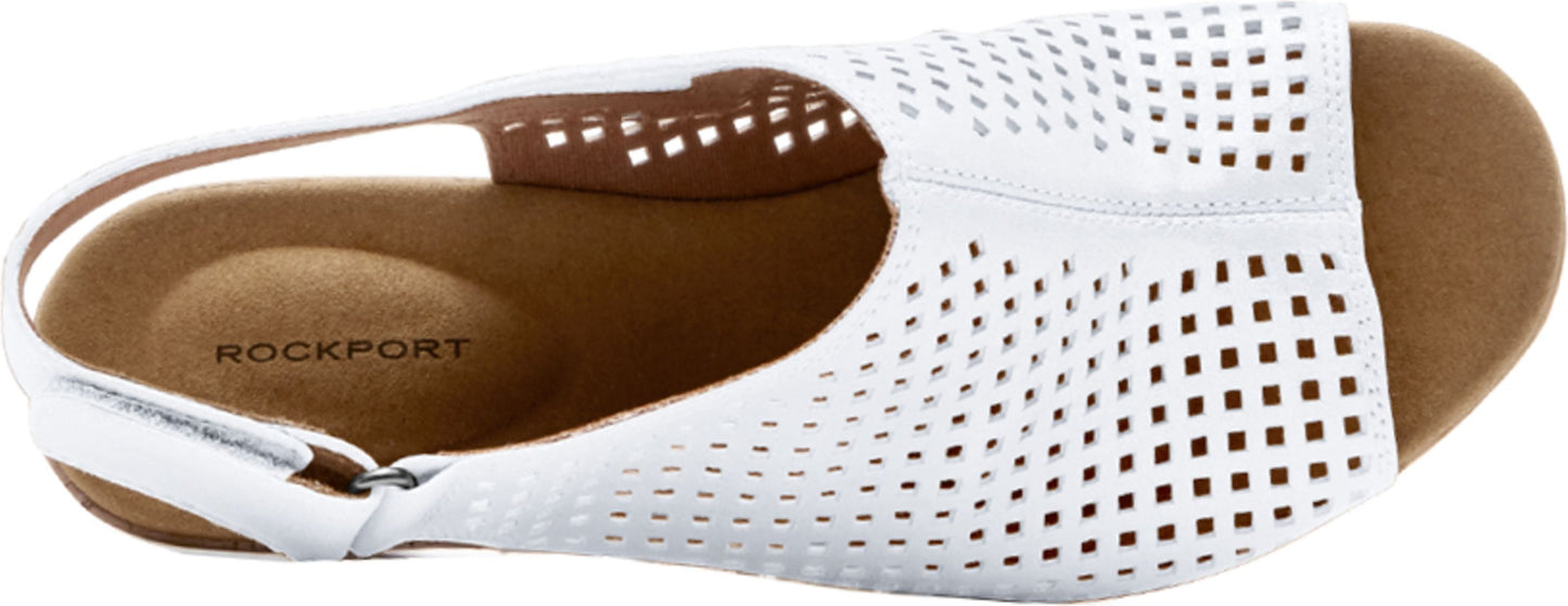 A white sandal with tiny square cutouts.