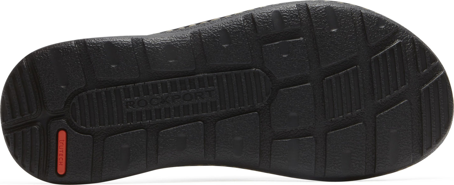 A black shoe sole with grip patterns and a visible red logo.